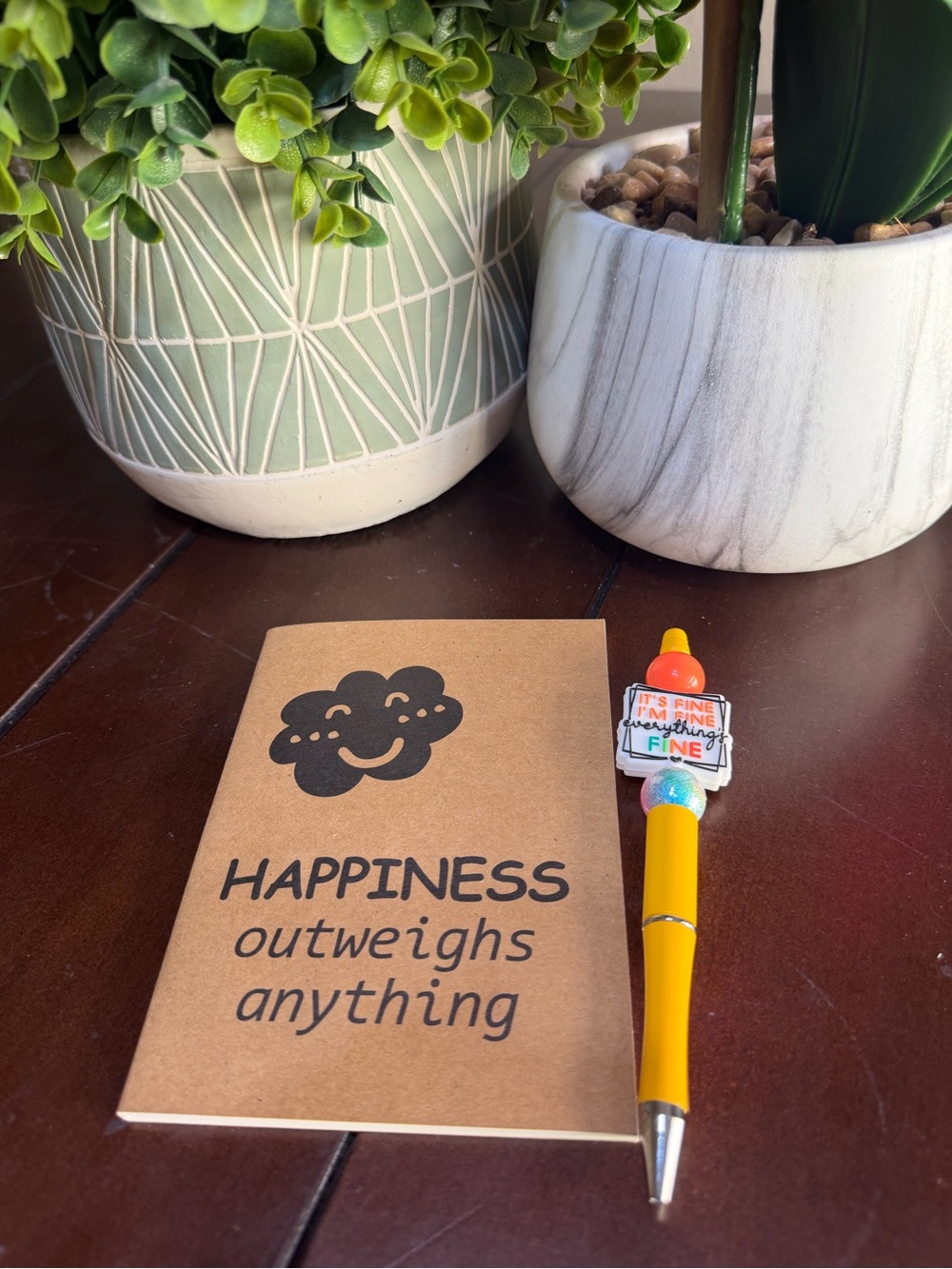 Journal ‘Happiness out weighs everything’ and pen.